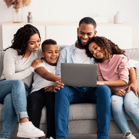 family on couch looking at computer